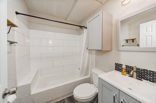 full bath with vanity, tasteful backsplash, toilet, and shower / bathtub combination with curtain
