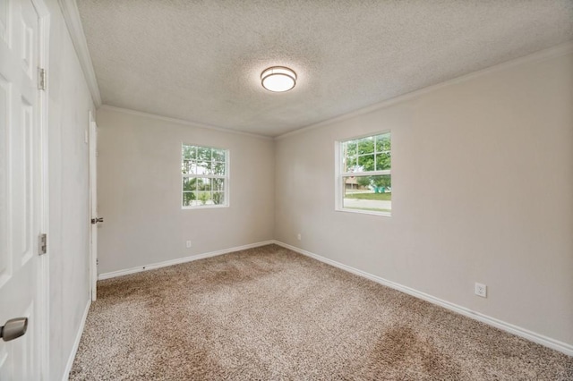 unfurnished room with crown molding, carpet floors, baseboards, and a textured ceiling