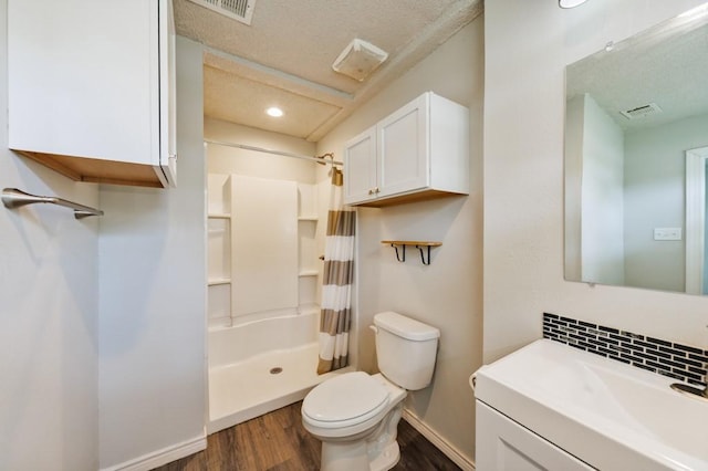 bathroom featuring visible vents, curtained shower, wood finished floors, baseboards, and toilet