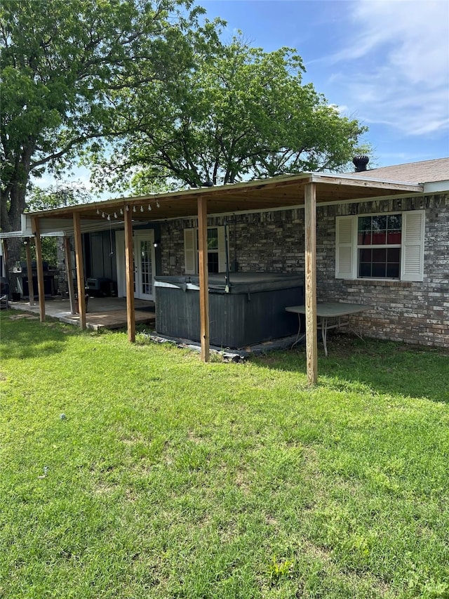 view of yard with a hot tub and a patio area