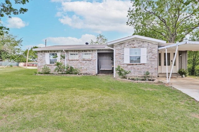 ranch-style home with brick siding, entry steps, a front yard, and a carport