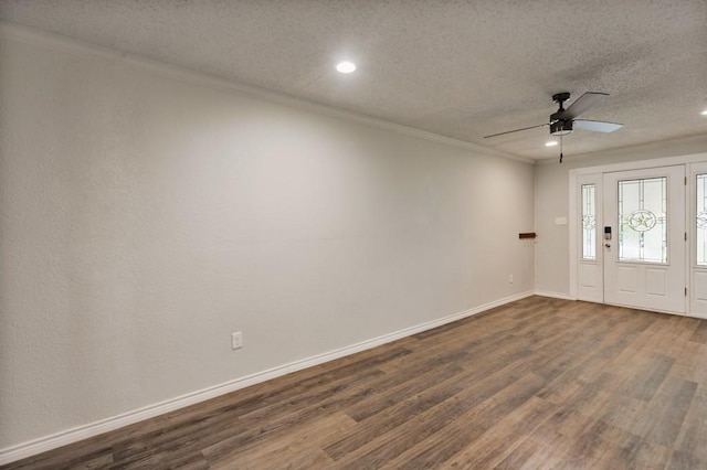 foyer featuring recessed lighting, ornamental molding, a textured ceiling, and dark wood finished floors