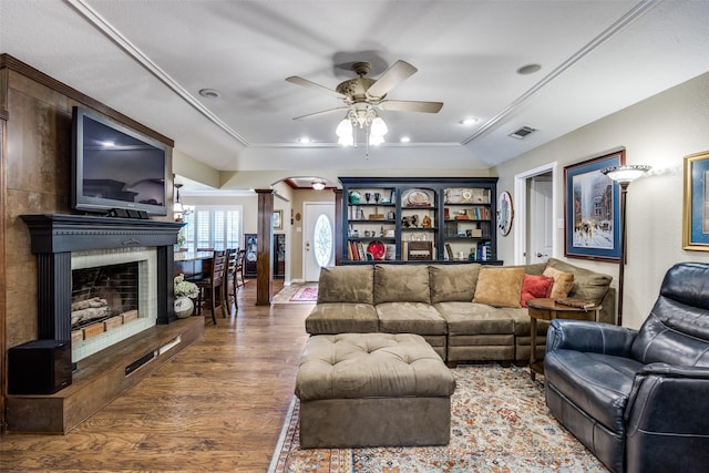 1621 Lake Hill Ln, Plano, TX 75023 - living room featuring decorative columns, wood finished floors, ceiling fan, arched walkways, and a fireplace with raised hearth