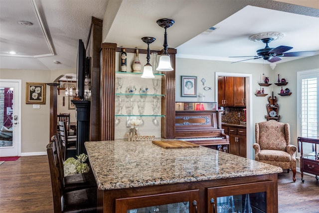 1621 Lake Hill Ln, Plano, TX 75023 - bar featuring ceiling fan, dark wood finished floors, baseboards, hanging light fixtures, and ornamental molding
