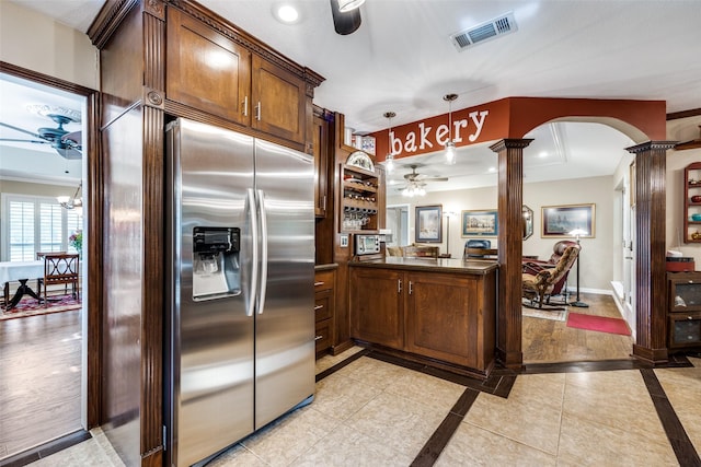 1621 Lake Hill Ln, Plano, TX 75023 - kitchen featuring ceiling fan, stainless steel fridge, dark countertops, arched walkways, and inlaid floor details