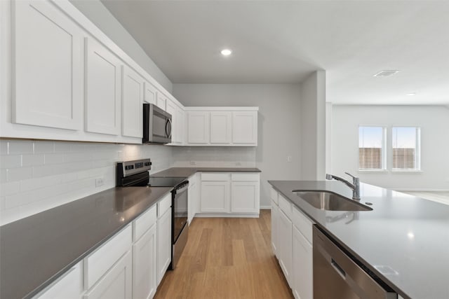 1946 Callington Way, Forney, TX 75126 - kitchen with light wood-style floors, a sink, white cabinetry, and stainless steel appliances