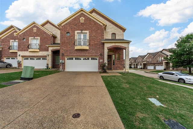 view of front facade with an attached garage, driveway, a balcony, and a front yard