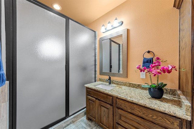 full bathroom featuring vanity and a stall shower