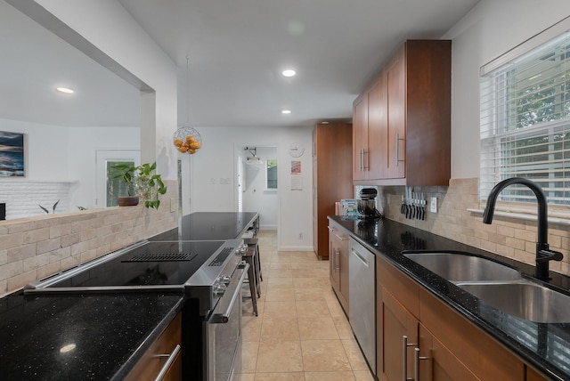 kitchen with stainless steel appliances, recessed lighting, a healthy amount of sunlight, and a sink
