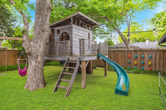 view of playground featuring a yard and fence private yard