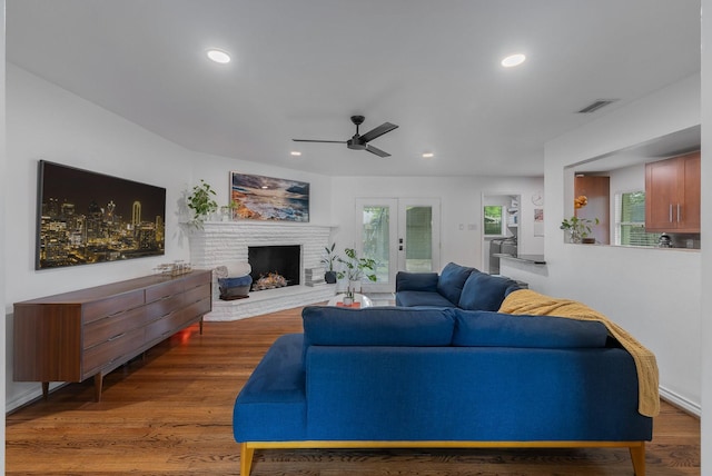 living area with a ceiling fan, visible vents, recessed lighting, and a fireplace