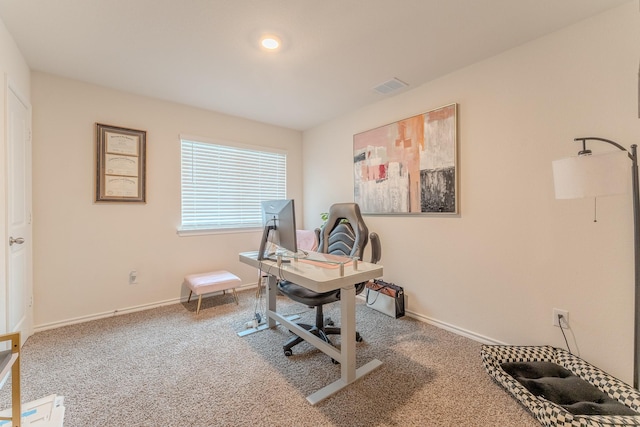 carpeted home office featuring visible vents and baseboards