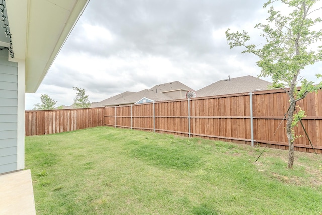 view of yard with a fenced backyard