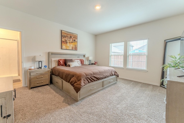 bedroom with baseboards and light carpet