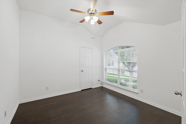 spare room featuring baseboards, ceiling fan, and dark wood-style floors