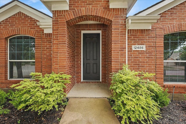property entrance with brick siding