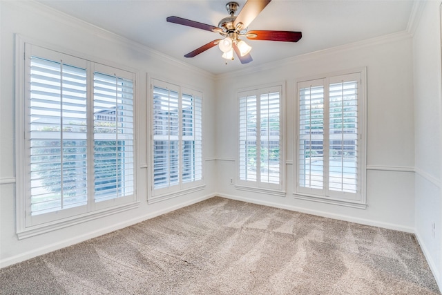 unfurnished room featuring ornamental molding, carpet, and a ceiling fan