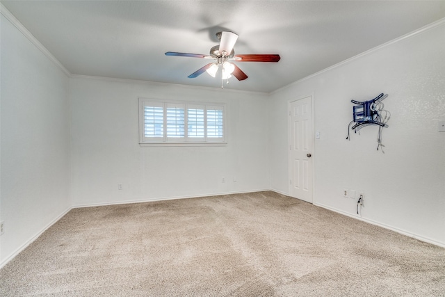 empty room featuring baseboards, a ceiling fan, carpet, and ornamental molding