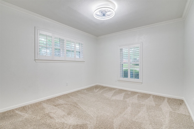 empty room with carpet floors, baseboards, and ornamental molding