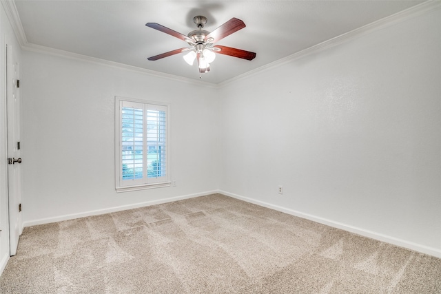 spare room featuring carpet floors, a ceiling fan, and ornamental molding