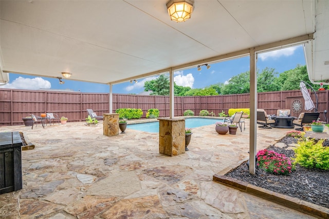 view of patio with a fenced in pool and a fenced backyard