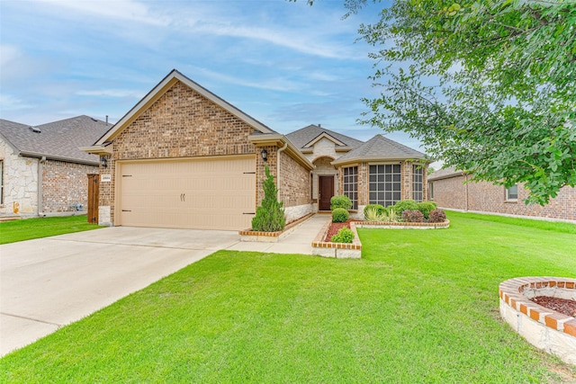 view of front of home with driveway, roof with shingles, a front yard, a garage, and brick siding