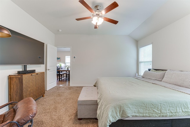 bedroom with a ceiling fan, baseboards, and light colored carpet