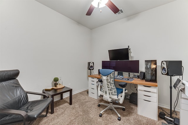 carpeted office space with visible vents, a ceiling fan, and baseboards