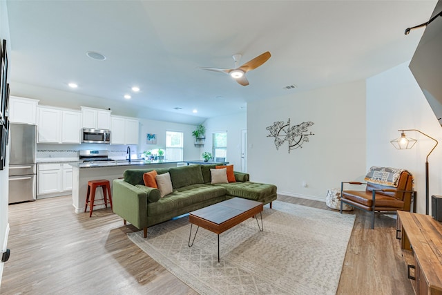 living room with visible vents, baseboards, light wood-type flooring, recessed lighting, and a ceiling fan