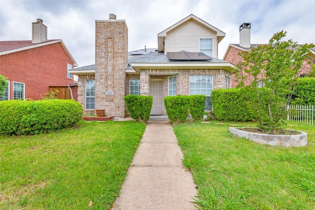 2839 Meadow Way Ln, Dallas, TX 75228 - bungalow-style house featuring fence, solar panels, a front lawn, and brick siding