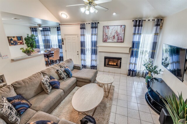 2839 Meadow Way Ln, Dallas, TX 75228 - living room featuring a ceiling fan, vaulted ceiling, light tile patterned floors, and a fireplace