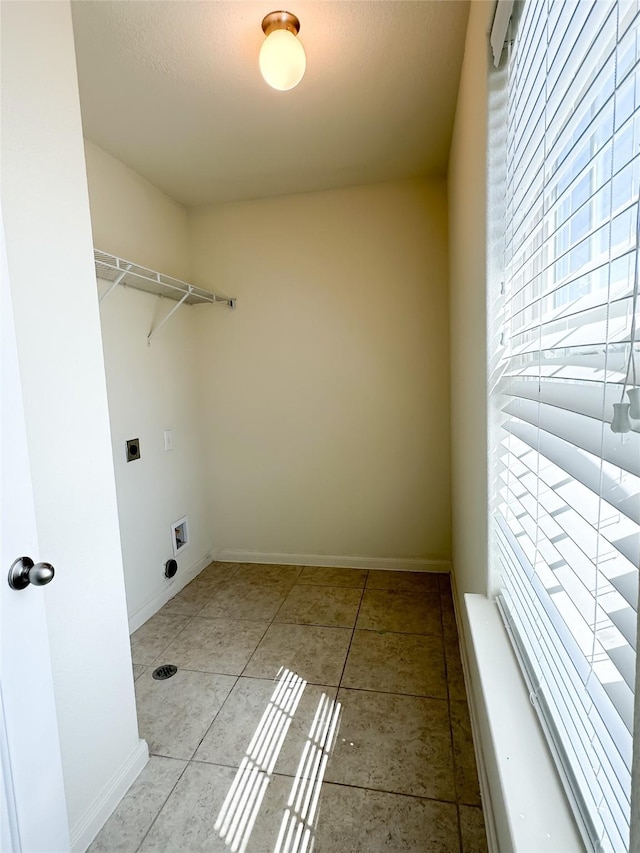 laundry room with baseboards, light tile patterned floors, laundry area, and electric dryer hookup