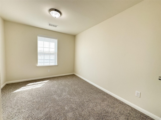 carpeted empty room with baseboards and visible vents