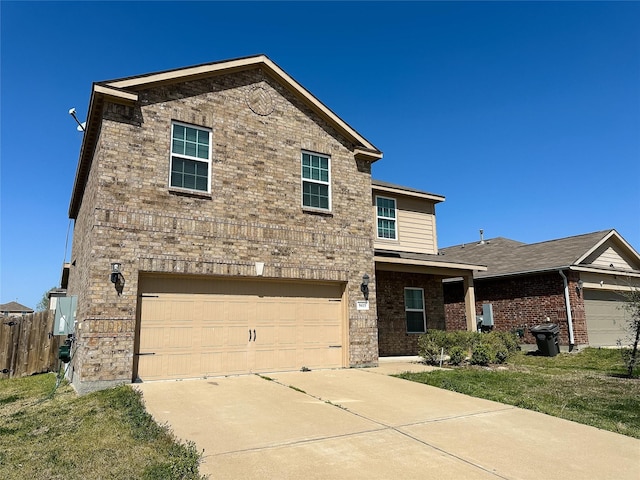 traditional-style home featuring brick siding, an attached garage, driveway, and fence
