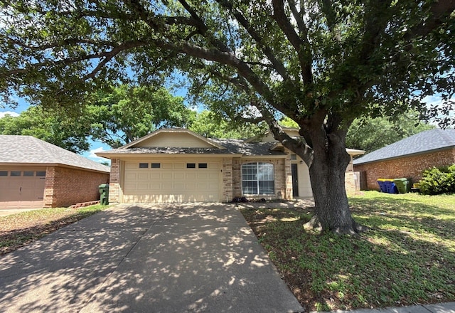 view of front of property with brick siding, a garage, and driveway