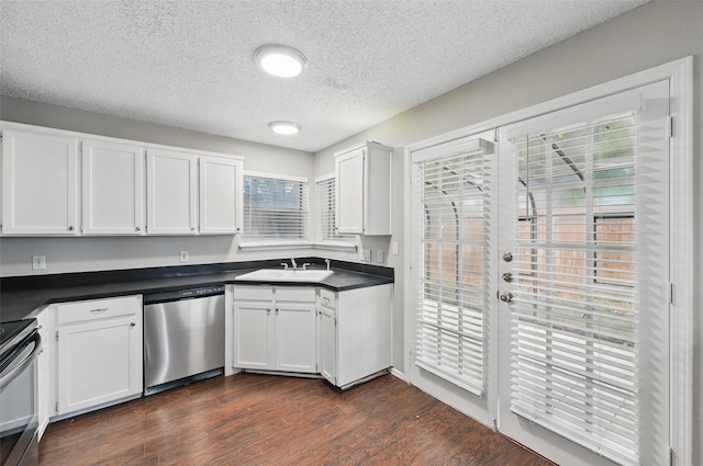 6317 N Park Dr, Watauga, TX 76148 - kitchen featuring a sink, a textured ceiling, appliances with stainless steel finishes, and dark countertops