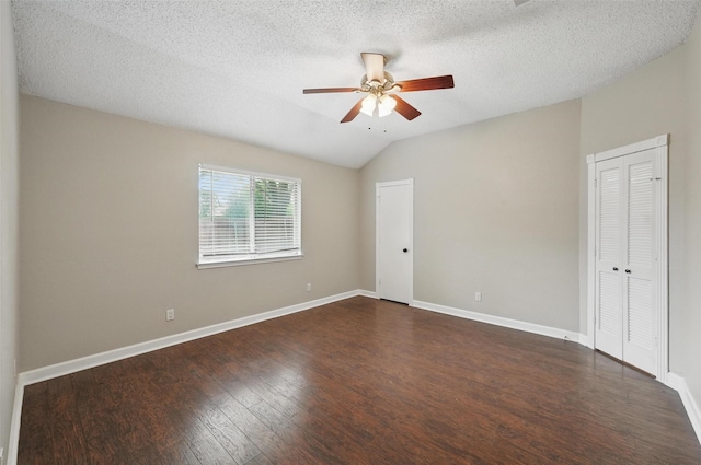 6317 N Park Dr, Watauga, TX 76148 - empty room with ceiling fan, a textured ceiling, baseboards, lofted ceiling, and dark wood-type flooring