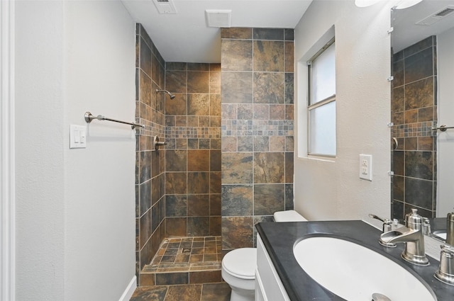 6317 N Park Dr, Watauga, TX 76148 - bathroom with toilet, visible vents, and tiled shower