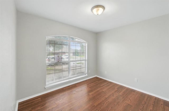 6317 N Park Dr, Watauga, TX 76148 - spare room with baseboards and dark wood finished floors