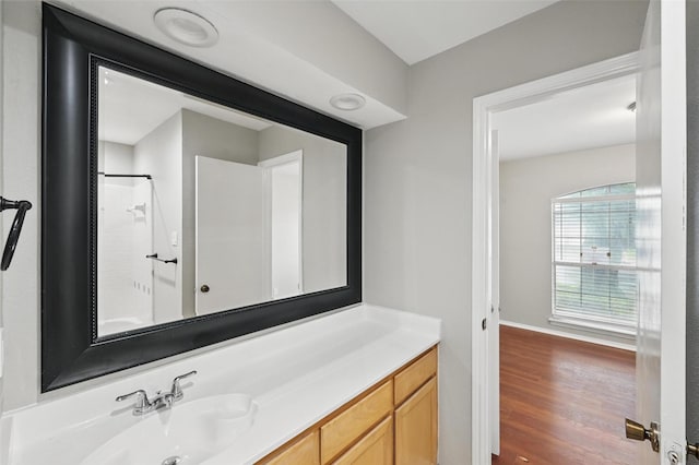 6317 N Park Dr, Watauga, TX 76148 - bathroom featuring vanity, baseboards, walk in shower, and wood finished floors