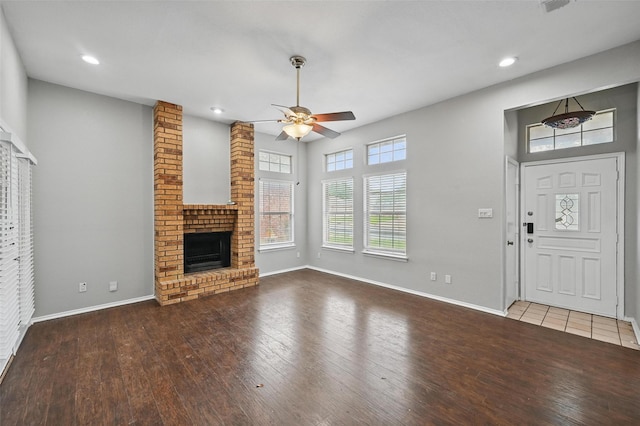 6317 N Park Dr, Watauga, TX 76148 - unfurnished living room with baseboards, wood-type flooring, a ceiling fan, and a brick fireplace