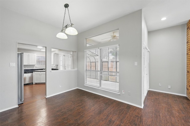 6317 N Park Dr, Watauga, TX 76148 - unfurnished dining area featuring a ceiling fan, baseboards, and dark wood-type flooring