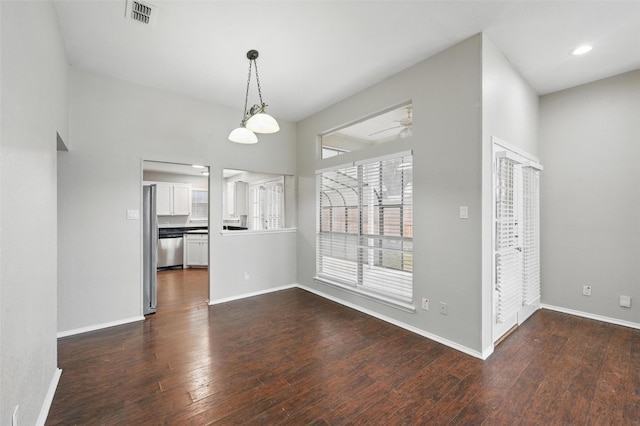 6317 N Park Dr, Watauga, TX 76148 - unfurnished dining area featuring baseboards, ceiling fan, dark wood-type flooring, and visible vents