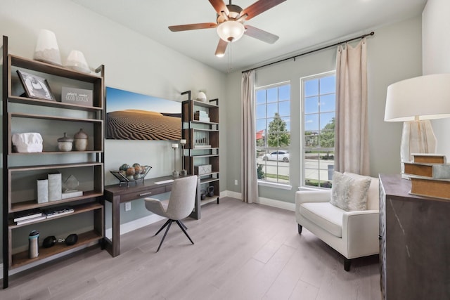 home office with baseboards, ceiling fan, and wood finished floors