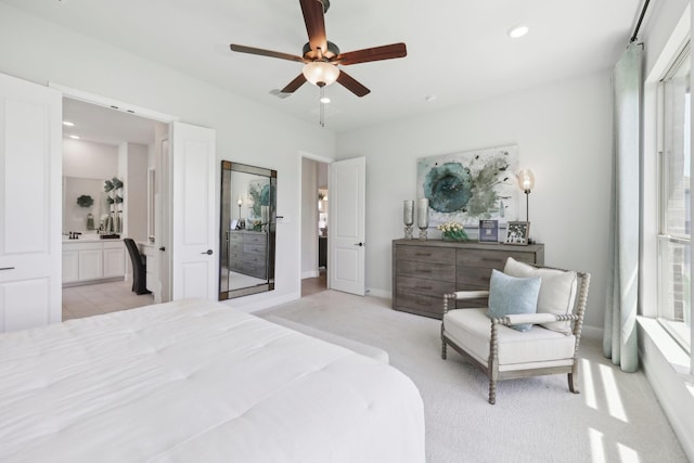bedroom with light carpet, baseboards, ceiling fan, recessed lighting, and ensuite bath
