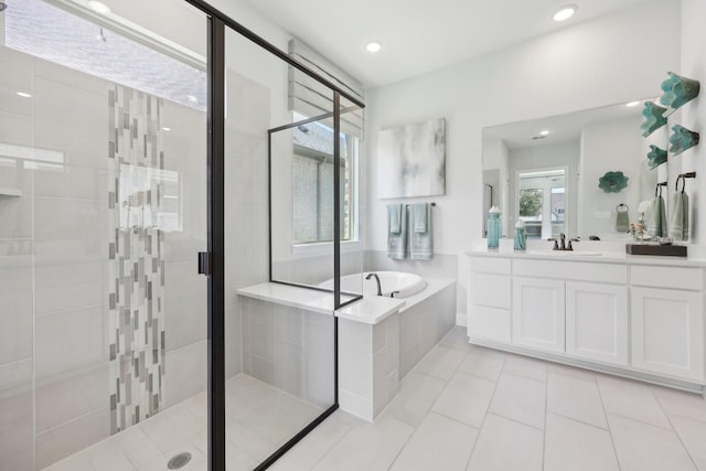 bathroom with vanity, tile patterned flooring, a garden tub, and a stall shower