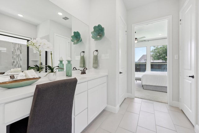 full bath featuring visible vents, a ceiling fan, double vanity, baseboards, and a sink