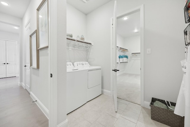 laundry area with baseboards, laundry area, recessed lighting, and washing machine and clothes dryer