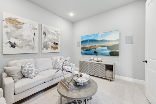 carpeted living area featuring baseboards and recessed lighting