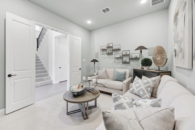 living area featuring recessed lighting, stairs, and visible vents